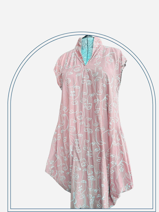 A dusty pink drapey dress with line drawings and a collar, displayed on a mannequin outdoors.