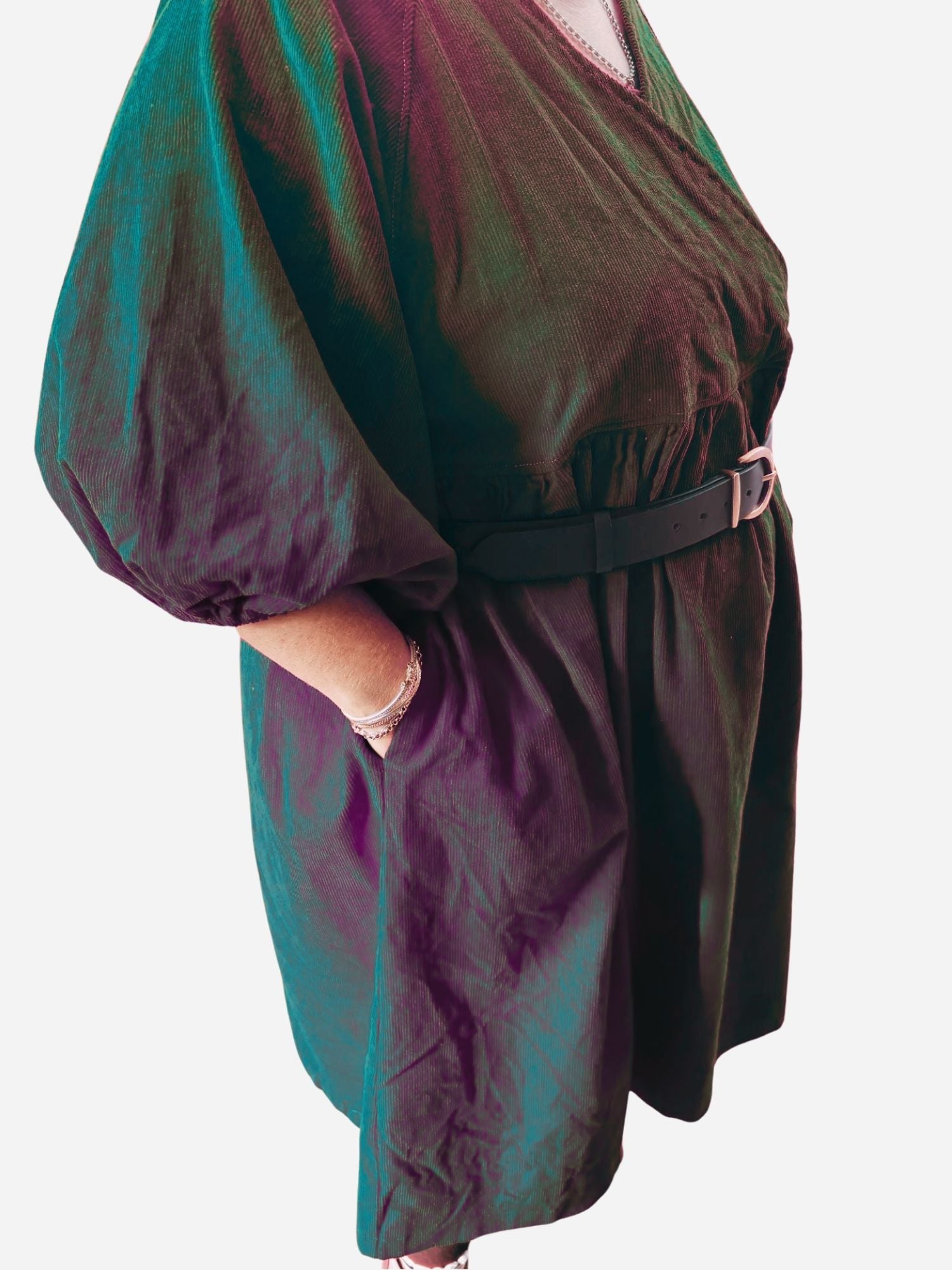 Person wearing a red dress with puffed sleeves on a wooden deck.