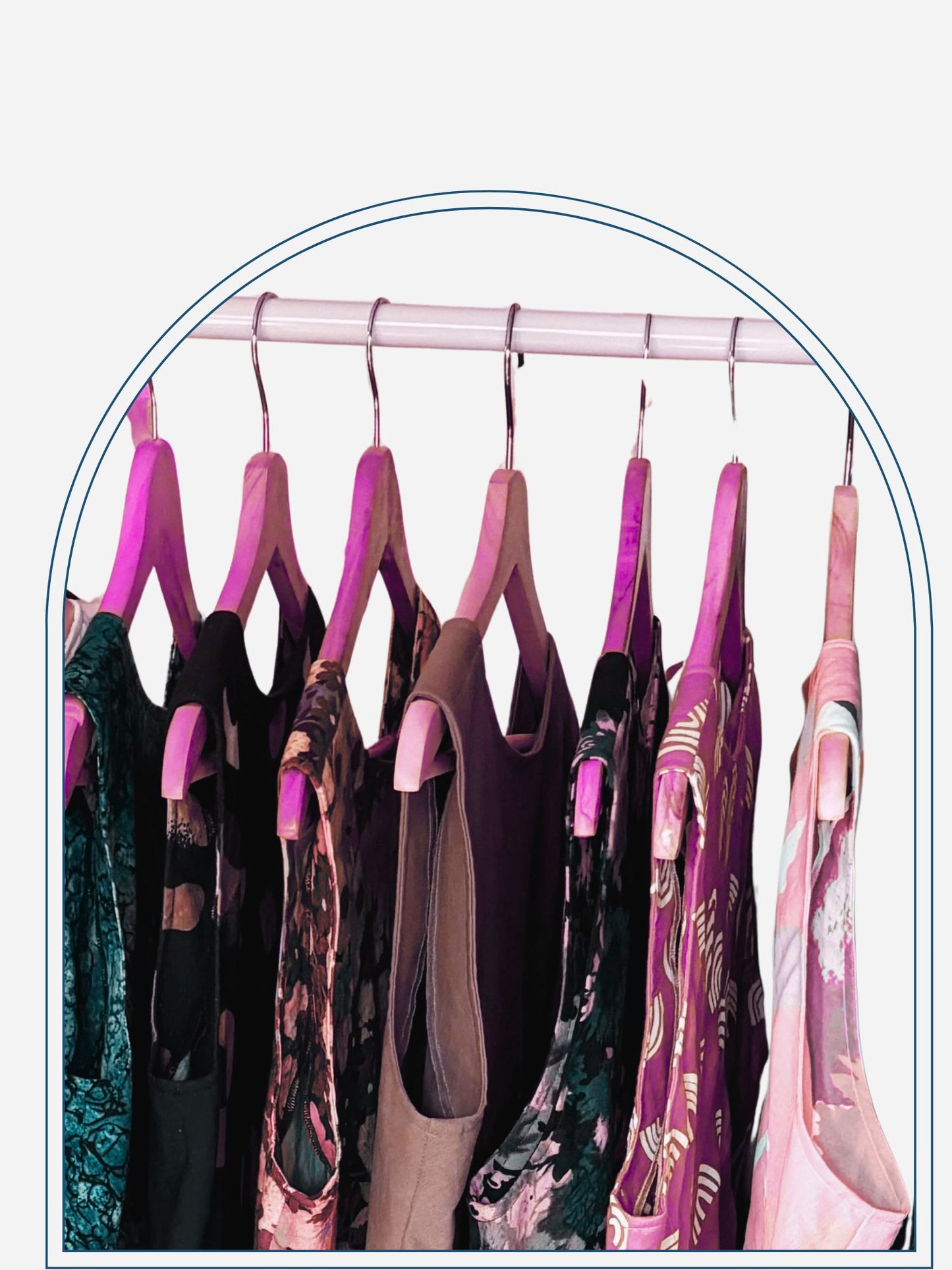 Clothing rack with various patterned shirts on a neutral background