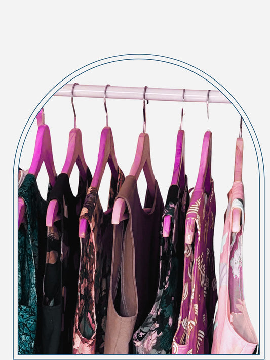Clothing rack with various patterned shirts on a neutral background